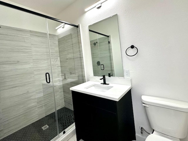 bathroom featuring vanity, toilet, and an enclosed shower