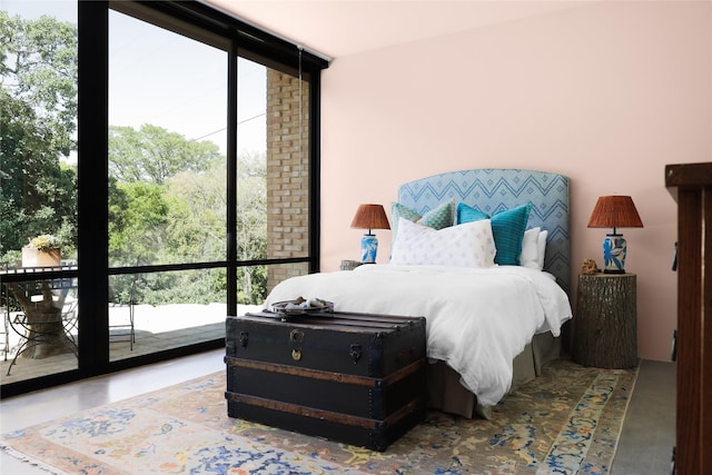 bedroom featuring multiple windows and a wall of windows