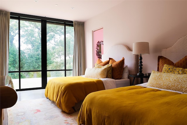 bedroom with expansive windows and access to outside