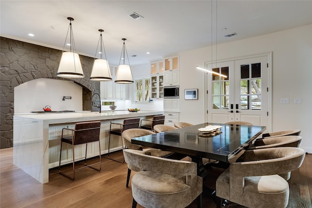 dining space featuring french doors and light hardwood / wood-style floors