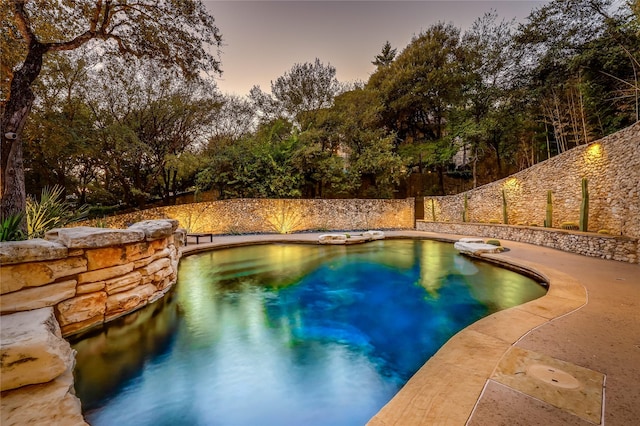 view of pool at dusk