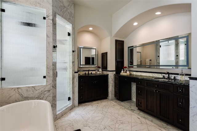 bathroom featuring vanity, tile walls, and independent shower and bath