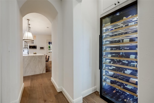 wine room featuring hardwood / wood-style flooring and sink