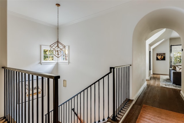 staircase featuring an inviting chandelier, wood-type flooring, and vaulted ceiling