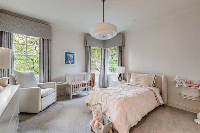 bedroom featuring light colored carpet, ornamental molding, and multiple windows