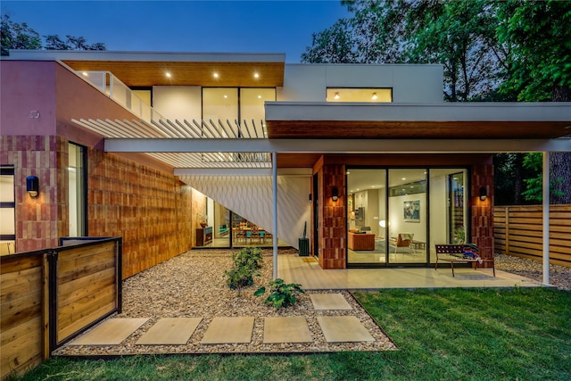 rear view of house featuring a yard and a patio