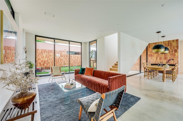 living room with concrete flooring and expansive windows