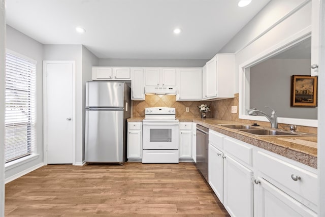 kitchen with white cabinets, backsplash, sink, and appliances with stainless steel finishes