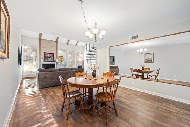 dining area with vaulted ceiling with beams, a healthy amount of sunlight, and an inviting chandelier