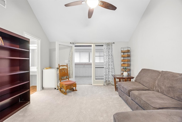 living room featuring light carpet, vaulted ceiling, and ceiling fan