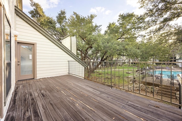 wooden terrace with a fenced in pool