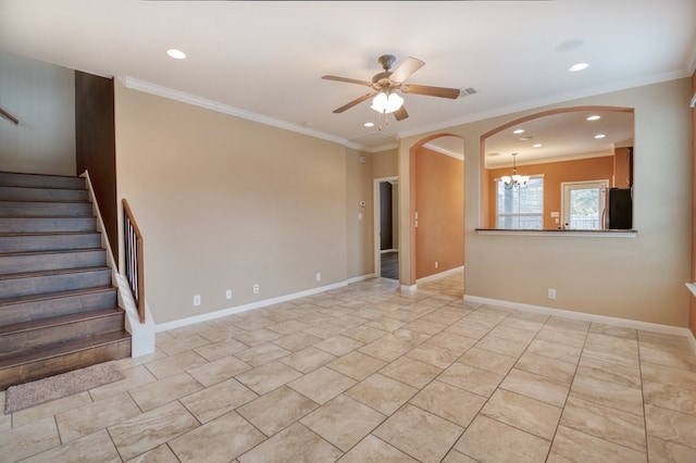 empty room with ceiling fan with notable chandelier and crown molding