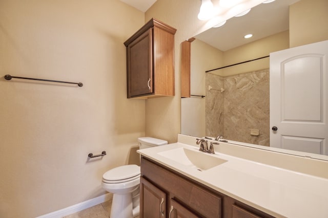 bathroom featuring toilet, tile patterned flooring, and vanity