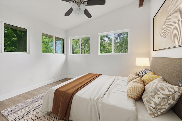 bedroom with ceiling fan, light hardwood / wood-style floors, and lofted ceiling