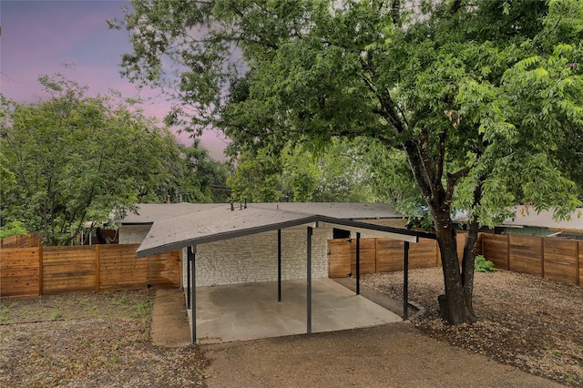 back house at dusk with a patio