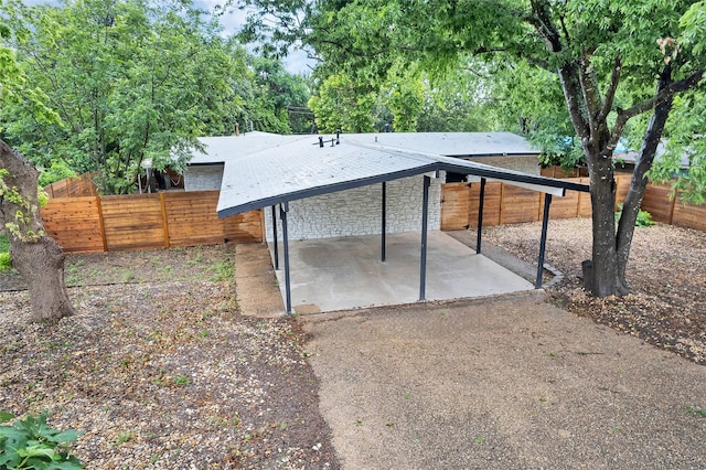 back of house featuring a carport