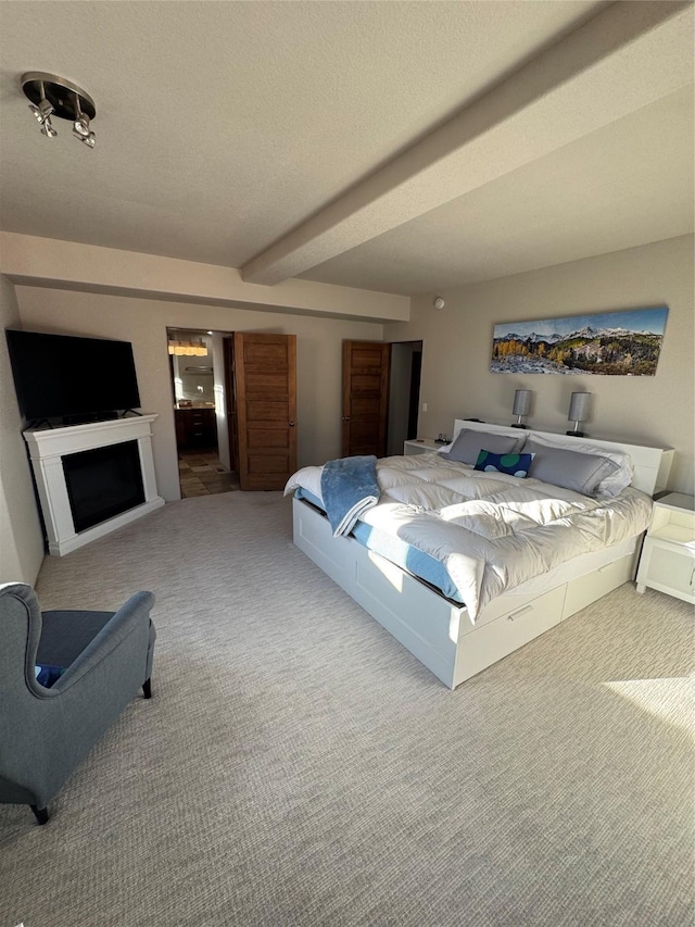 bedroom with carpet and beam ceiling