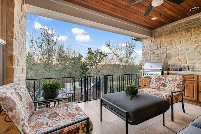 balcony with a sink, a grill, an outdoor kitchen, and a ceiling fan