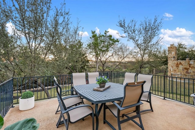 view of patio / terrace with a balcony and outdoor dining area