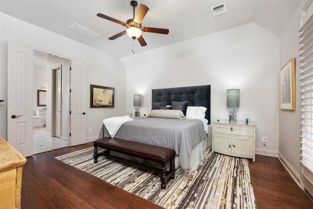 bedroom featuring lofted ceiling, visible vents, baseboards, and wood finished floors