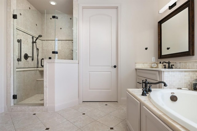 bathroom featuring a garden tub, a sink, a shower stall, baseboards, and tile patterned floors