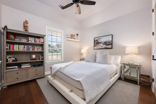 bedroom with a ceiling fan, dark wood-style flooring, visible vents, and baseboards