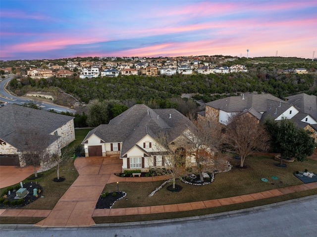 aerial view at dusk featuring a residential view