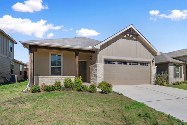 view of front of property with cooling unit, a garage, and a front lawn