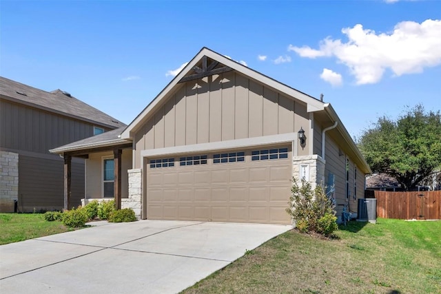 view of front facade with a front lawn, fence, board and batten siding, concrete driveway, and an attached garage