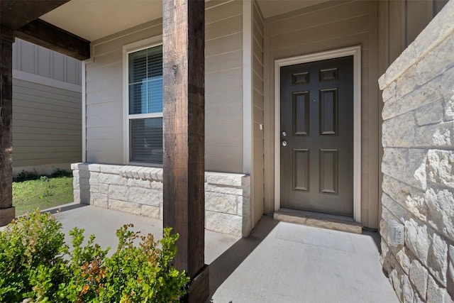 1420 Cliffbrake Way, Georgetown, TX 78626 - view of exterior entry with stone siding, covered porch, and board and batten siding