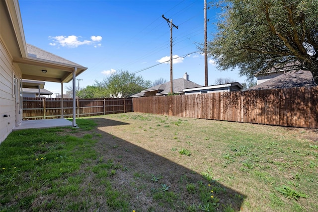 view of yard with a fenced backyard