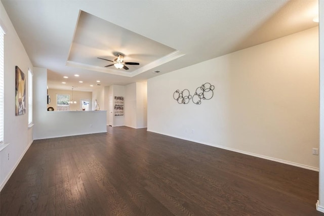 1420 Cliffbrake Way, Georgetown, TX 78626 - unfurnished living room featuring a tray ceiling, a ceiling fan, dark wood-type flooring, and recessed lighting