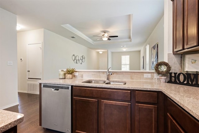 1420 Cliffbrake Way, Georgetown, TX 78626 - kitchen with stainless steel dishwasher, a raised ceiling, backsplash, a ceiling fan, and dark wood-style flooring