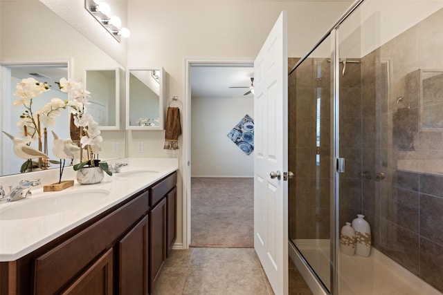 full bath with a sink, double vanity, a stall shower, and tile patterned floors