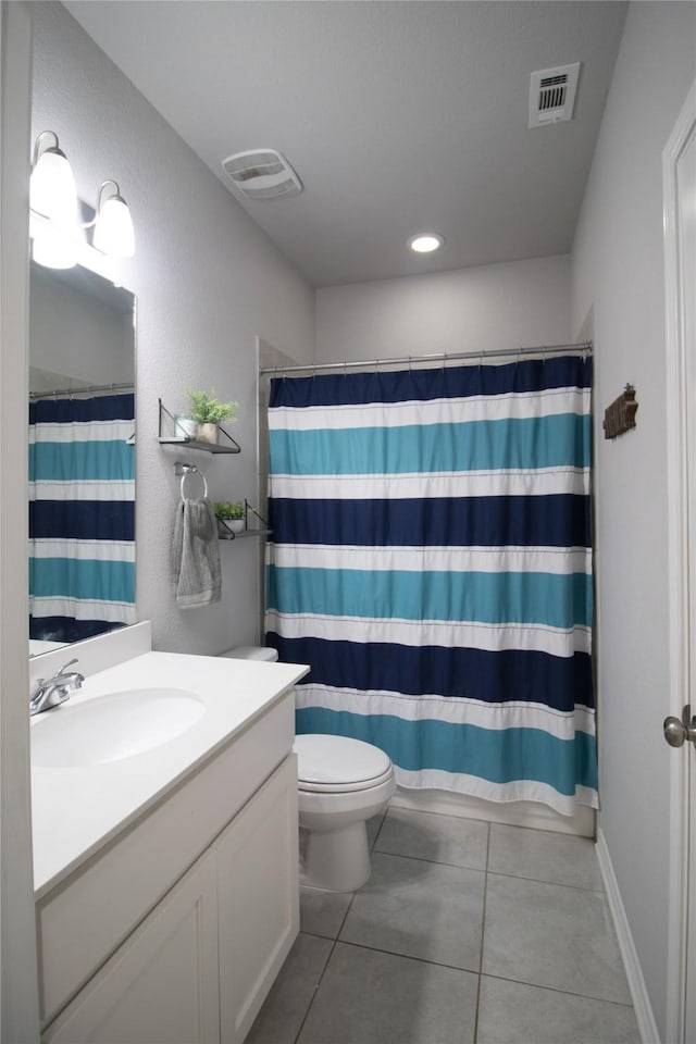 bathroom with tile patterned floors, vanity, curtained shower, and toilet