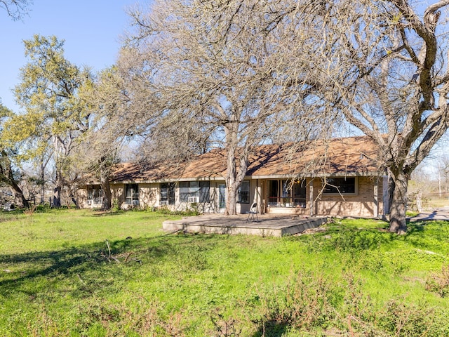 back of property featuring a yard