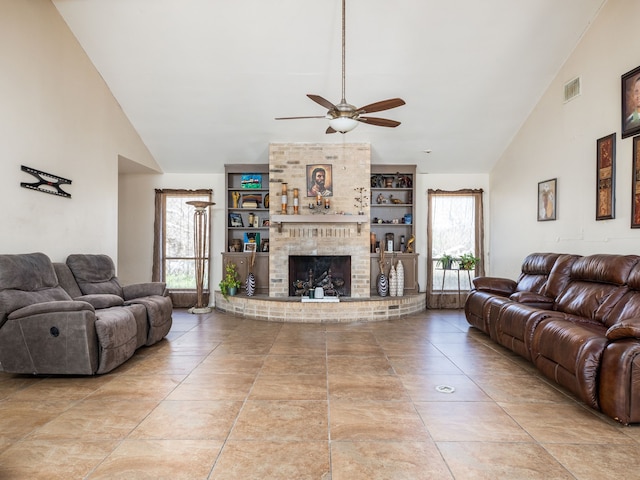 living room with a fireplace, plenty of natural light, lofted ceiling, and ceiling fan