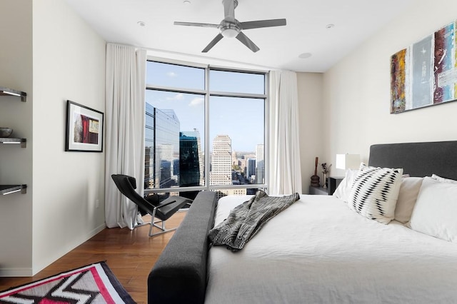 bedroom with floor to ceiling windows, ceiling fan, and hardwood / wood-style flooring