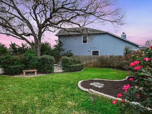 view of yard at dusk