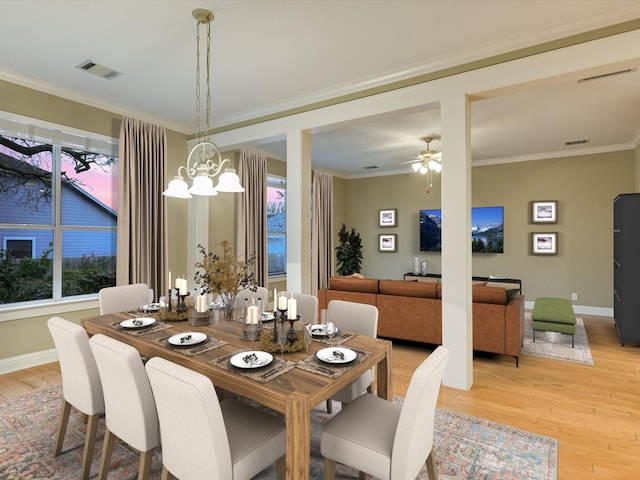 dining area with ceiling fan with notable chandelier, light hardwood / wood-style floors, and ornamental molding