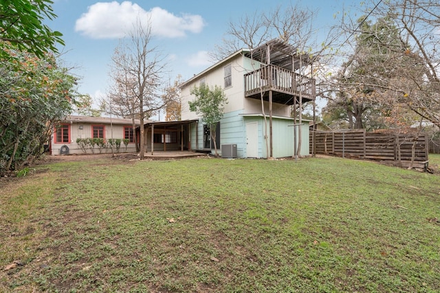 back of property with a yard, a balcony, cooling unit, and a patio area