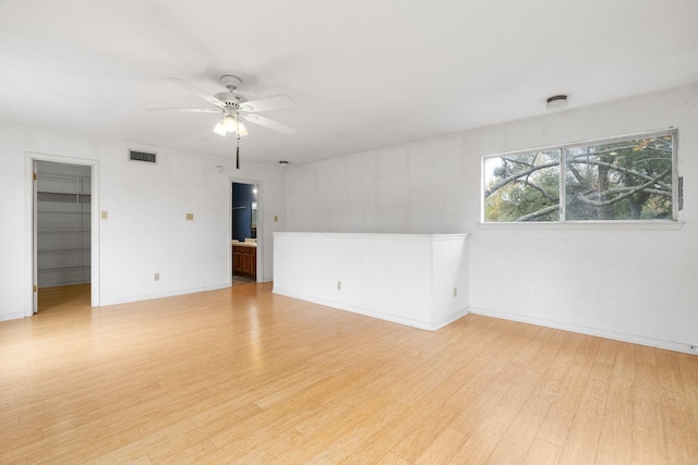 unfurnished room with ceiling fan and light hardwood / wood-style flooring