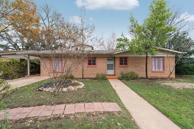 view of front of house with a front lawn and a carport