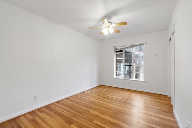 empty room featuring ceiling fan and light hardwood / wood-style floors