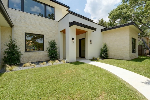 doorway to property with a yard