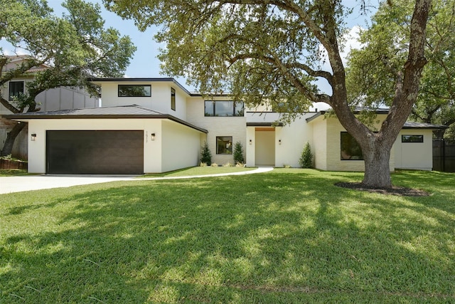 view of front of property with a garage and a front lawn