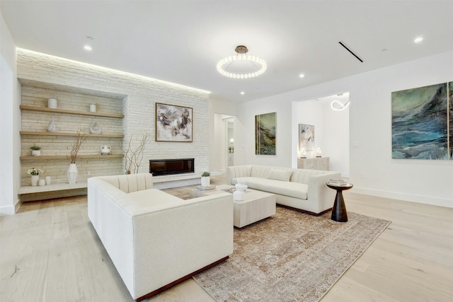 living room with light wood-type flooring and a fireplace