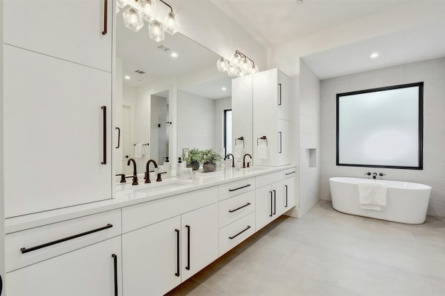 bathroom with vanity, a healthy amount of sunlight, shower with separate bathtub, and tile walls