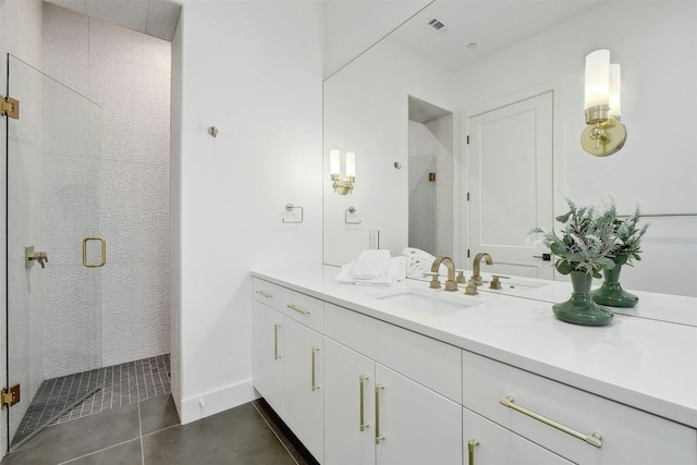 bathroom featuring tile patterned floors, vanity, and walk in shower