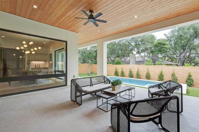 view of patio / terrace with ceiling fan and a fenced in pool